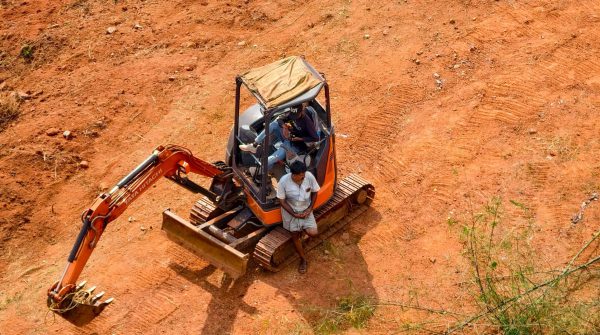 Industrial excavator digging on a construction site, highlighting earth-moving operations.